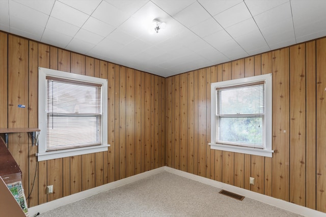 7102 E Bridgeport Ave, Spokane Valley, WA 99212 - carpeted spare room featuring wooden walls and baseboards