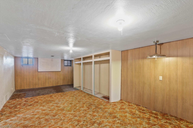 7102 E Bridgeport Ave, Spokane Valley, WA 99212 - below grade area featuring wooden walls, a textured ceiling, and carpet flooring