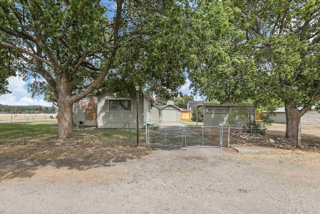7102 E Bridgeport Ave, Spokane Valley, WA 99212 - view of front of house with a gate and an outdoor structure