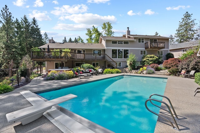 5321 Pinebrook Ct, Spokane, WA 99206 - swimming pool with stairs, a diving board, a deck, and a patio area