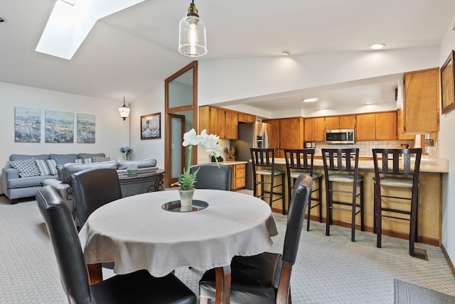 5321 Pinebrook Ct, Spokane, WA 99206 - dining area with light carpet, vaulted ceiling, a skylight, and recessed lighting