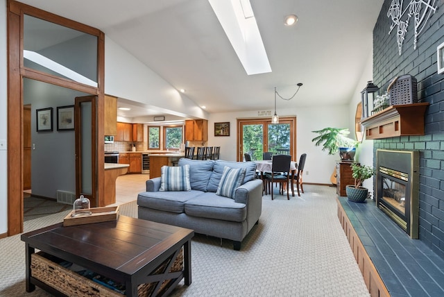 5321 Pinebrook Ct, Spokane, WA 99206 - living room with a skylight, light colored carpet, a fireplace, wine cooler, and high vaulted ceiling