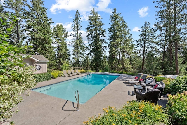 5321 Pinebrook Ct, Spokane, WA 99206 - view of pool with a patio area, a diving board, and view of wooded area