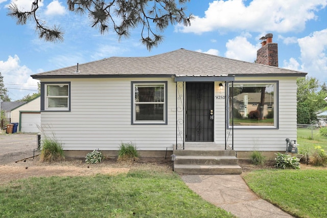 2509 W Upton Ave, Spokane, WA 99205 - view of front of property featuring a chimney, a front lawn, and a shingled roof