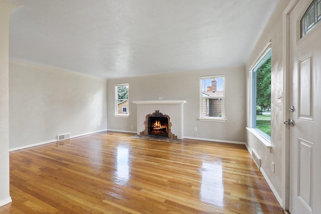 2509 W Upton Ave, Spokane, WA 99205 - unfurnished living room with light wood-style floors and a fireplace