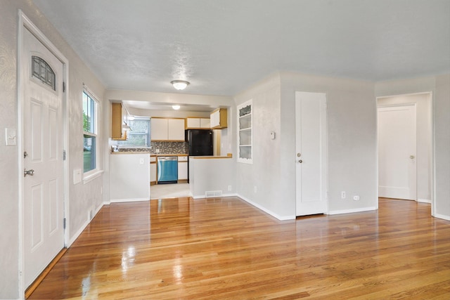 2509 W Upton Ave, Spokane, WA 99205 - unfurnished living room with light wood-style floors and baseboards