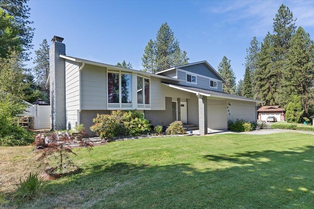404 E Carriage Ct, Spokane, WA 99218 - tri-level home with a chimney, brick siding, a front yard, and a garage