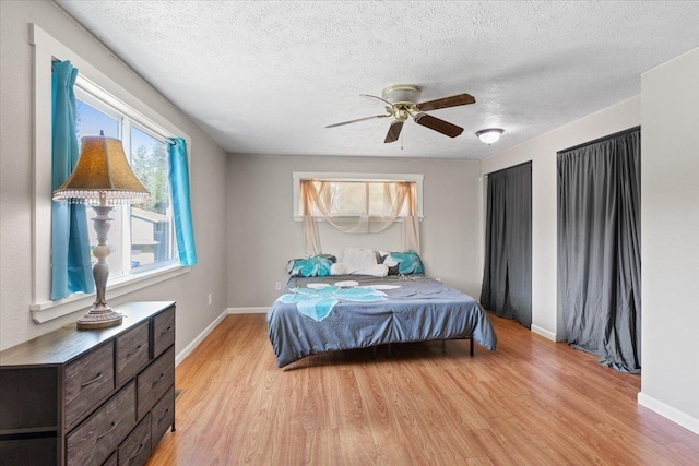 404 E Carriage Ct, Spokane, WA 99218 - bedroom featuring light wood-type flooring, a textured ceiling, and a ceiling fan