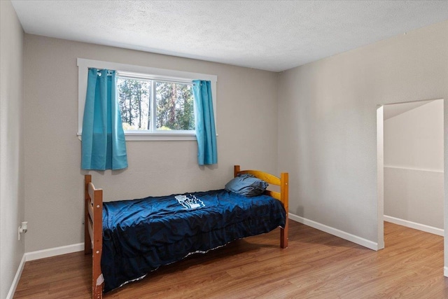 404 E Carriage Ct, Spokane, WA 99218 - bedroom with light wood-style floors and a textured ceiling