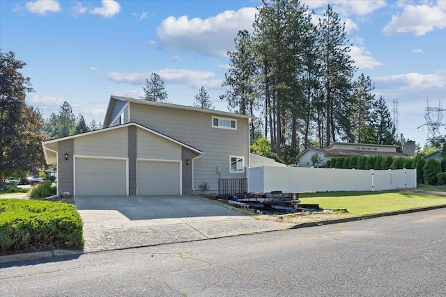 404 E Carriage Ct, Spokane, WA 99218 - view of property exterior with driveway and a garage
