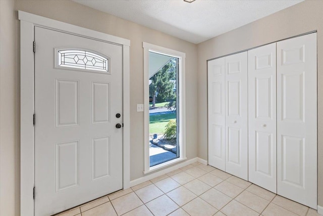 404 E Carriage Ct, Spokane, WA 99218 - foyer with light tile patterned floors and a textured ceiling