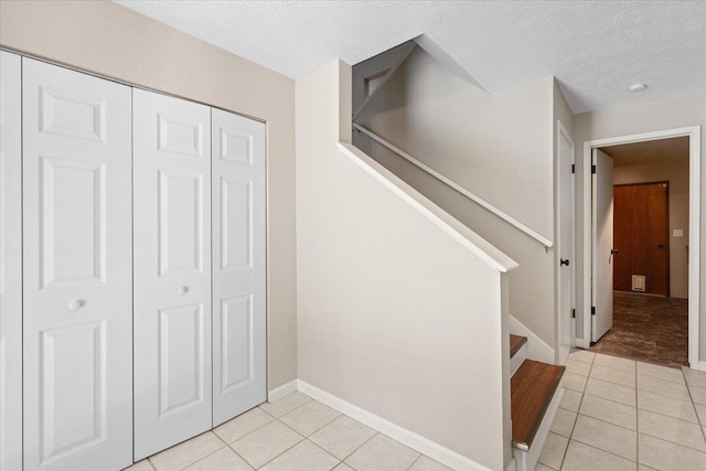 404 E Carriage Ct, Spokane, WA 99218 - staircase with tile patterned floors and a textured ceiling