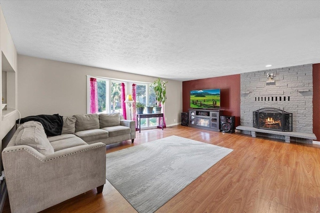404 E Carriage Ct, Spokane, WA 99218 - living room featuring wood finished floors, a fireplace, and a textured ceiling