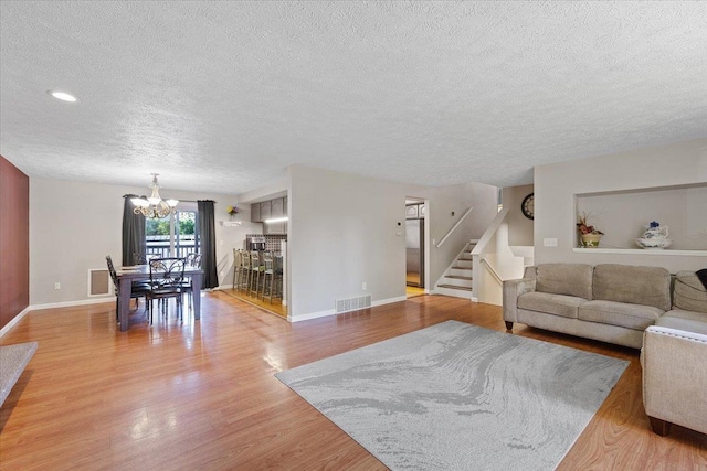 404 E Carriage Ct, Spokane, WA 99218 - living area with a textured ceiling, a chandelier, stairway, light wood-type flooring, and recessed lighting