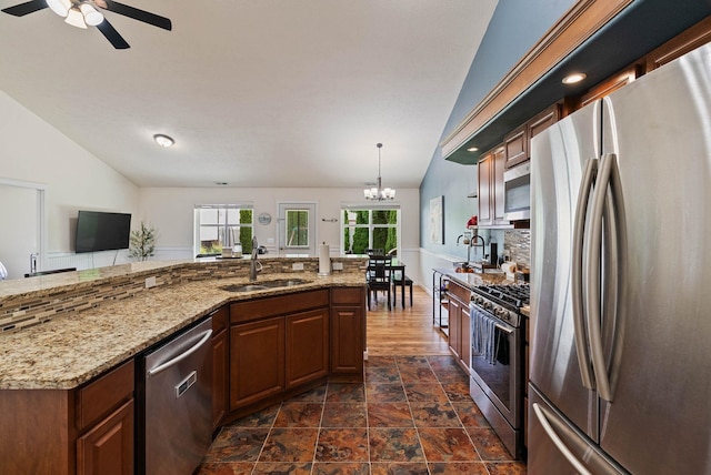 17309 E Baldwin Ave, Spokane Valley, WA 99016 - kitchen featuring appliances with stainless steel finishes, vaulted ceiling, a chandelier, ceiling fan, and light stone counters