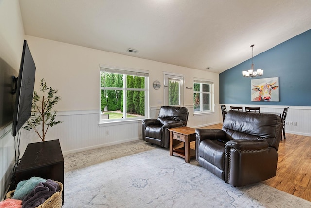 17309 E Baldwin Ave, Spokane Valley, WA 99016 - living room with wainscoting, a chandelier, vaulted ceiling, and wood finished floors