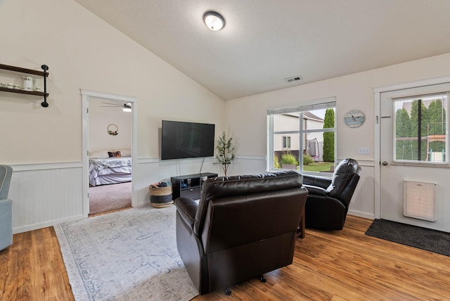 17309 E Baldwin Ave, Spokane Valley, WA 99016 - living room with light wood-type flooring, a wainscoted wall, lofted ceiling, heating unit, and ceiling fan