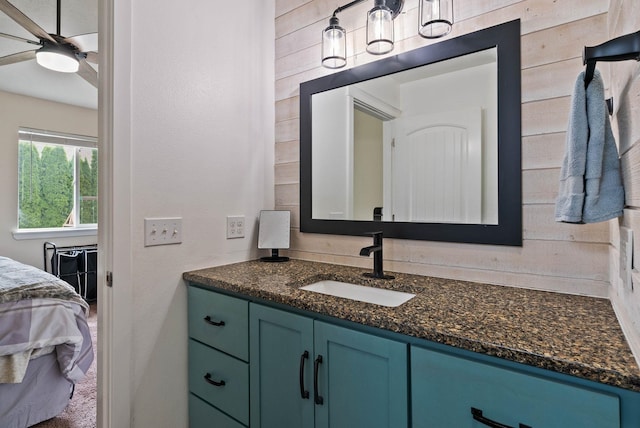 17309 E Baldwin Ave, Spokane Valley, WA 99016 - ensuite bathroom featuring vanity, ceiling fan, and wood walls