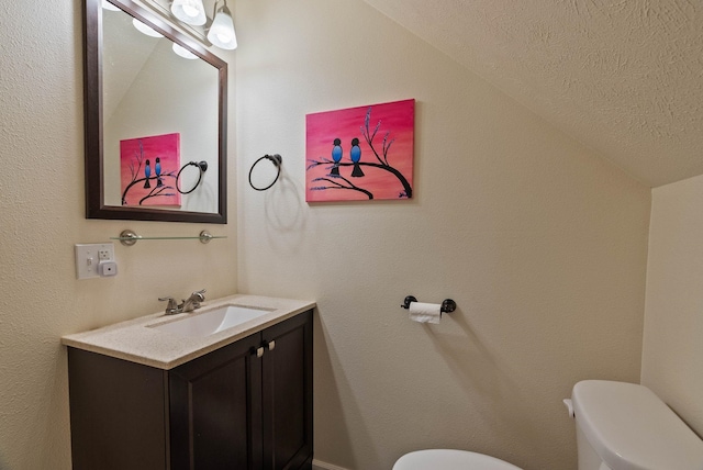 17309 E Baldwin Ave, Spokane Valley, WA 99016 - half bathroom with lofted ceiling, vanity, and a textured ceiling