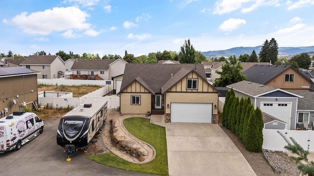 17309 E Baldwin Ave, Spokane Valley, WA 99016 - view of front of property with board and batten siding, a residential view, driveway, a garage, and a mountain view