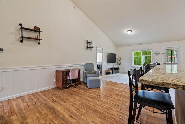 17309 E Baldwin Ave, Spokane Valley, WA 99016 - dining area featuring light wood-style floors, a wainscoted wall, and lofted ceiling