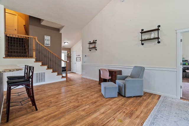 17309 E Baldwin Ave, Spokane Valley, WA 99016 - living area featuring wood finished floors, stairs, a wainscoted wall, and lofted ceiling
