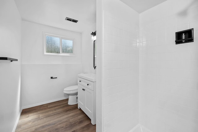 12024 E Buckeye Ave, Spokane Valley, WA 99206 - bathroom featuring vanity, wood finished floors, and a tile shower