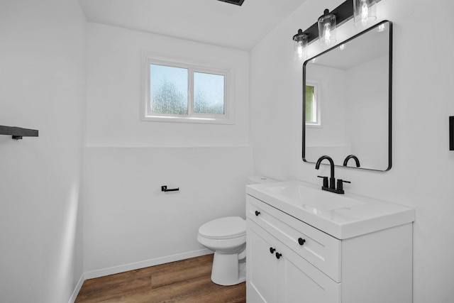 12024 E Buckeye Ave, Spokane Valley, WA 99206 - half bathroom with vanity, plenty of natural light, and wood finished floors