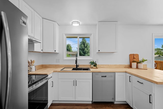 12024 E Buckeye Ave, Spokane Valley, WA 99206 - kitchen with stainless steel appliances, wooden counters, a peninsula, white cabinets, and under cabinet range hood