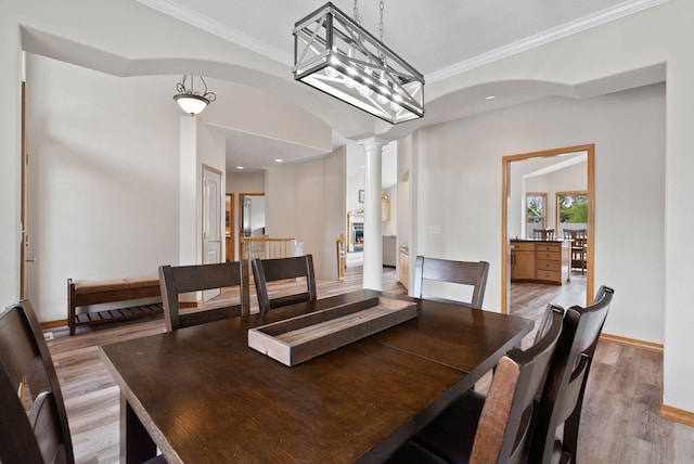 17110 E Daybreak Ln, Spokane Valley, WA 99016 - dining room with decorative columns, light wood-style floors, ornamental molding, arched walkways, and recessed lighting