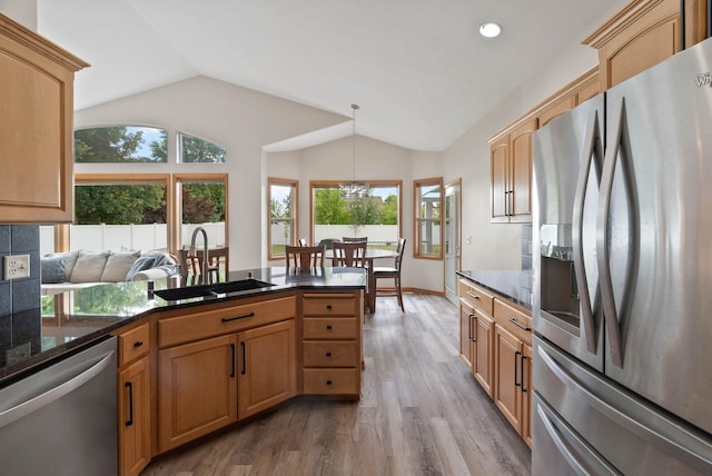 17110 E Daybreak Ln, Spokane Valley, WA 99016 - kitchen with appliances with stainless steel finishes, wood finished floors, vaulted ceiling, a chandelier, and pendant lighting