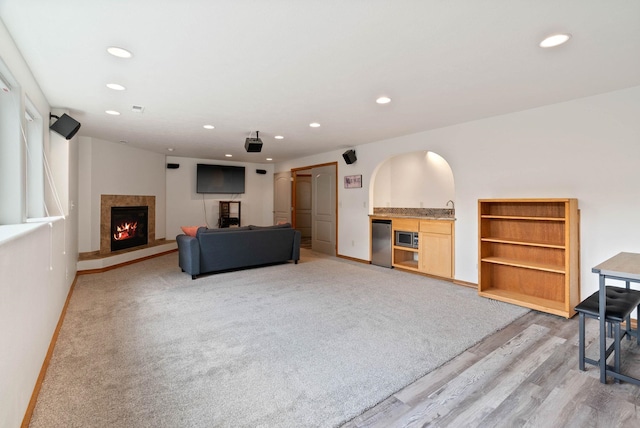 17110 E Daybreak Ln, Spokane Valley, WA 99016 - living room featuring recessed lighting, a high end fireplace, light wood-type flooring, and bar area