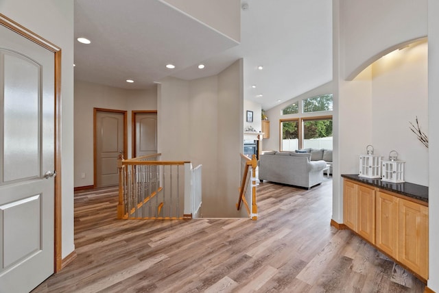 17110 E Daybreak Ln, Spokane Valley, WA 99016 - hall featuring an upstairs landing, light wood-style flooring, recessed lighting, arched walkways, and vaulted ceiling