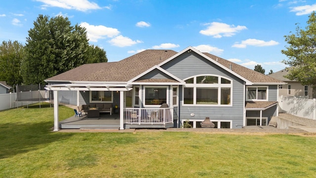 17110 E Daybreak Ln, Spokane Valley, WA 99016 - back of property with a trampoline, an outdoor living space, a fenced backyard, roof with shingles, and a pergola