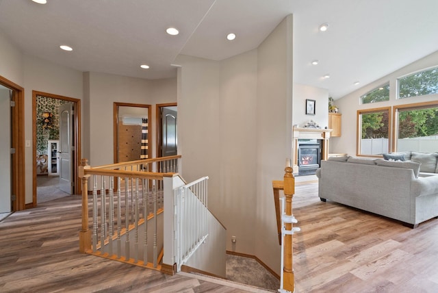 17110 E Daybreak Ln, Spokane Valley, WA 99016 - hallway with an upstairs landing, light wood finished floors, recessed lighting, vaulted ceiling, and an AC wall unit