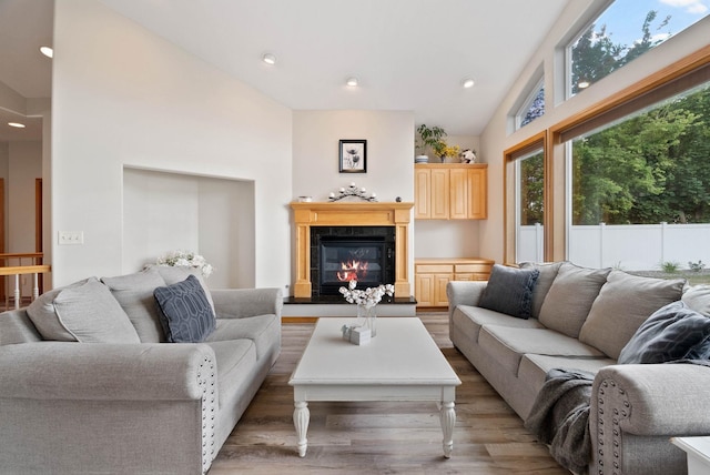17110 E Daybreak Ln, Spokane Valley, WA 99016 - living room featuring wood finished floors, recessed lighting, a tile fireplace, and lofted ceiling