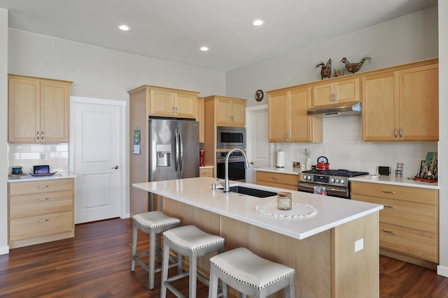 8510 N Jodi St, Spokane, WA 99208 - kitchen featuring appliances with stainless steel finishes, light brown cabinets, under cabinet range hood, decorative backsplash, and recessed lighting