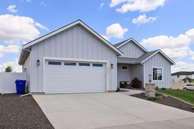 8510 N Jodi St, Spokane, WA 99208 - view of front of home with board and batten siding, a garage, driveway, and roof with shingles