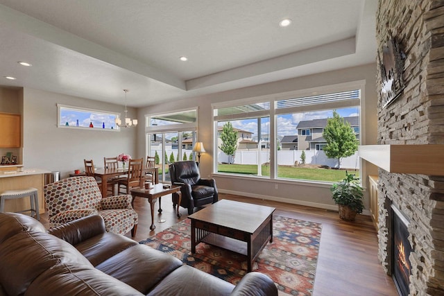8510 N Jodi St, Spokane, WA 99208 - living area with a stone fireplace, a chandelier, wood finished floors, and recessed lighting