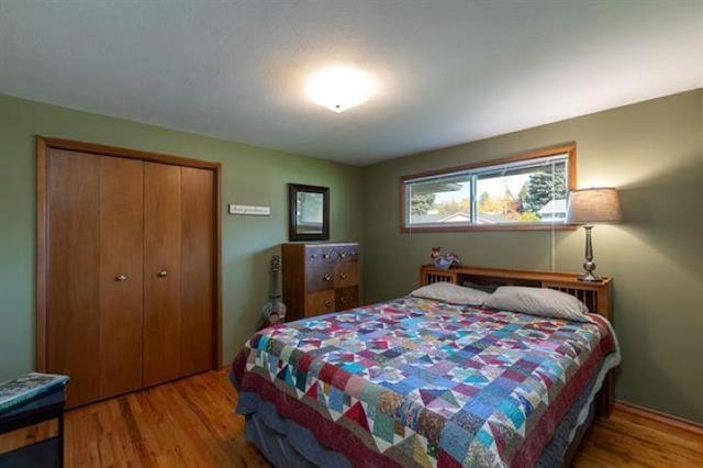 5801 N Drumheller St, Spokane, WA 99205 - bedroom featuring wood finished floors and a closet
