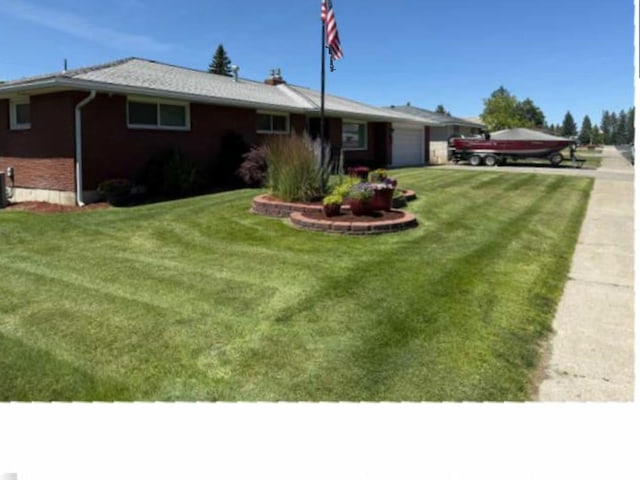 5801 N Drumheller St, Spokane, WA 99205 - ranch-style house with a garage, a front lawn, brick siding, and driveway