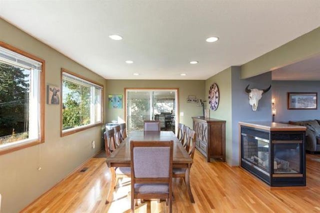 5801 N Drumheller St, Spokane, WA 99205 - dining room with light wood finished floors, recessed lighting, and a multi sided fireplace