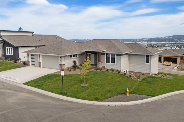 16931 E 16th Ln, Spokane Valley, WA 99037 - view of front facade with a garage, driveway, and a front lawn