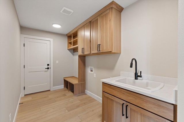 16931 E 16th Ln, Spokane Valley, WA 99037 - laundry area with washer hookup, light wood-style flooring, and cabinet space