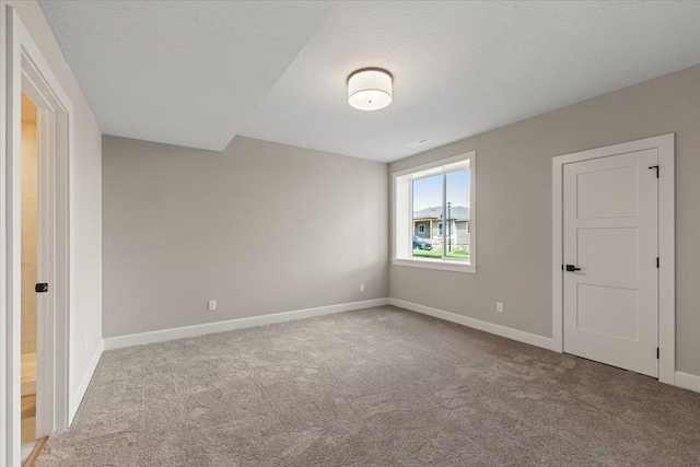 16931 E 16th Ln, Spokane Valley, WA 99037 - unfurnished bedroom featuring carpet flooring and a textured ceiling