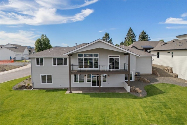 16931 E 16th Ln, Spokane Valley, WA 99037 - rear view of house featuring a patio area, a lawn, and a balcony