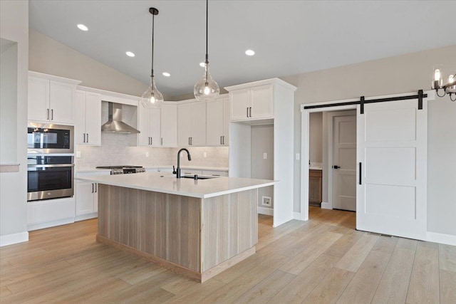 16931 E 16th Ln, Spokane Valley, WA 99037 - kitchen featuring appliances with stainless steel finishes, wall chimney exhaust hood, light countertops, decorative backsplash, and recessed lighting