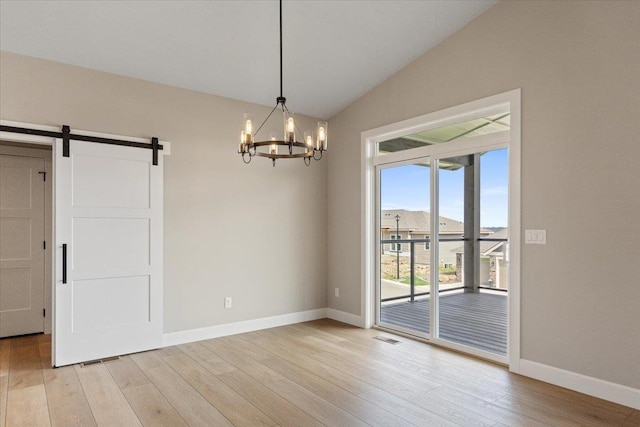 16931 E 16th Ln, Spokane Valley, WA 99037 - spare room featuring lofted ceiling, light wood finished floors, a barn door, and a chandelier