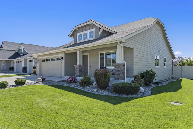 2373 N Colonial Rd, Liberty Lake, WA 99016 - view of front of home with a porch, concrete driveway, an attached garage, and roof with shingles