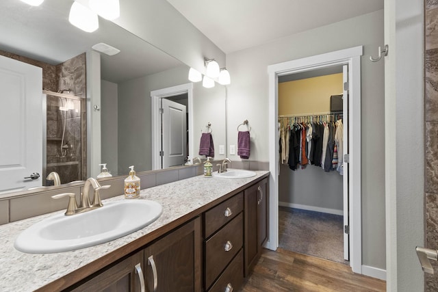 2373 N Colonial Rd, Liberty Lake, WA 99016 - bathroom with double vanity, a shower stall, wood finished floors, and a walk in closet